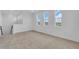 Second floor loft area featuring neutral carpet and windows with golf course views at 2626 Wise River Lane, Zephyrhills, FL 33539