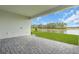 Covered patio with stone pavers and a beautiful view of the lake and treeline at 2626 Wise River Lane, Zephyrhills, FL 33539