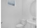 Clean powder room featuring a pedestal sink and modern fixtures at 2626 Wise River Lane, Zephyrhills, FL 33539