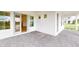 Covered front porch with gray brick pavers and double doors at 3611 Lajuana Blvd, Wesley Chapel, FL 33543
