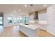 Modern kitchen featuring a large island and white cabinetry at 3611 Lajuana Blvd, Wesley Chapel, FL 33543