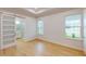 Bright bedroom with wood floors and barn door to bathroom at 3611 Lajuana Blvd, Wesley Chapel, FL 33543