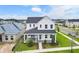 Two-story white farmhouse with a gray roof and landscaped yard at 3611 Lajuana Blvd, Wesley Chapel, FL 33543