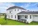 White two-story house with covered patio and landscaped yard at 3611 Lajuana Blvd, Wesley Chapel, FL 33543