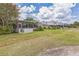 Villa backyard with a screened in porch and a green lawn at 13619 Twin Lakes Ln # 15, Tampa, FL 33618
