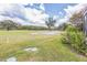 Residential backyard with golf course, green grass and blue skies at 13619 Twin Lakes Ln # 15, Tampa, FL 33618