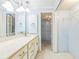Bright bathroom features a spacious vanity, neutral countertop, and walk-in closet for ample storage at 13619 Twin Lakes Ln # 15, Tampa, FL 33618