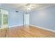 Empty bedroom with hardwood floors and a glass door leading to the bathroom at 13619 Twin Lakes Ln # 15, Tampa, FL 33618