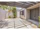 Charming front courtyard with a modern door and decorative pergola, enhancing curb appeal at 13619 Twin Lakes Ln # 15, Tampa, FL 33618