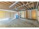 Spacious garage featuring concrete flooring, open ceiling, and built-in wooden storage cabinets along the side wall at 13619 Twin Lakes Ln # 15, Tampa, FL 33618