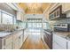 Galley kitchen with granite countertops, white cabinets and stainless steel appliances at 13619 Twin Lakes Ln # 15, Tampa, FL 33618