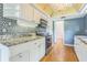 Kitchen view of backsplash, stone countertops, stainless appliances, and white cabinetry at 13619 Twin Lakes Ln # 15, Tampa, FL 33618
