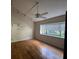 Bright bedroom with hardwood floors, large window, and ceiling fan at 13619 Twin Lakes Ln # 15, Tampa, FL 33618
