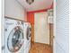 Laundry room with white washer and dryer, storage cabinets, and door at 13619 Twin Lakes Ln # 15, Tampa, FL 33618