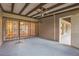 Enclosed patio with security bars on window; door leads to home's interior at 13619 Twin Lakes Ln # 15, Tampa, FL 33618