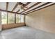 Enclosed patio with white textured wall and a large window offering a lush outdoor view at 13619 Twin Lakes Ln # 15, Tampa, FL 33618
