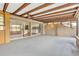 Large enclosed patio with ceiling beams and sliding doors leading to the interior spaces at 13619 Twin Lakes Ln # 15, Tampa, FL 33618