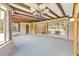 Spacious enclosed patio with ceiling beams, chandelier, and view into interior room with sliding doors at 13619 Twin Lakes Ln # 15, Tampa, FL 33618