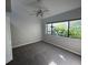 Carpeted bedroom with large window and ceiling fan at 13619 Twin Lakes Ln # 15, Tampa, FL 33618