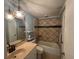 Bathroom with tile shower/tub surround, vanity, and decorative light fixture at 13619 Twin Lakes Ln # 15, Tampa, FL 33618