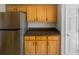 View of kitchen with stainless steel refrigerator and wood cabinets at 27724 Sora Blvd, Wesley Chapel, FL 33544