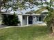 Light blue single story home with a well manicured lawn and covered entryway at 5400 Circle Dr, Weeki Wachee, FL 34607