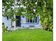 House exterior view, featuring a lush green lawn and mature trees at 5400 Circle Dr, Weeki Wachee, FL 34607