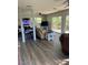 Bright living room with open floor plan, featuring a large TV and comfortable seating at 707 George S St, Tarpon Springs, FL 34688