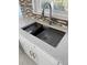 Modern kitchen sink with stainless steel grid and accessories at 1007 Normandy Rd, Clearwater, FL 33764