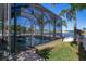 Screened pool and patio area with lake view at 1708 Hadden Hall Pl, Trinity, FL 34655