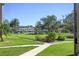 View of a grassy courtyard, lush landscaping, and building exterior at 5095 Bay Ne St # 109, St Petersburg, FL 33703