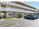 Exterior view of condo building with parking lot and landscaping at 5095 Bay Ne St # 109, St Petersburg, FL 33703