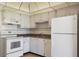 White kitchen with appliances and wood floor at 5095 Bay Ne St # 109, St Petersburg, FL 33703
