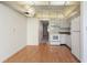 Bright kitchen features light wood laminate flooring, white cabinets, and appliances at 5095 Bay Ne St # 109, St Petersburg, FL 33703