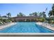 Community pool with lounge chairs and patio area at 5095 Bay Ne St # 109, St Petersburg, FL 33703