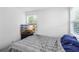 Bright bedroom with a TV and a striped comforter at 8106 N Klondyke St, Tampa, FL 33604