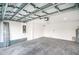 A large, empty two car garage features a concrete floor and insulated roof at 16126 Ivy Ridge Ct, Port Charlotte, FL 33953