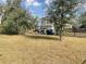 Large front yard with mature trees and a black metal fence at 3319 N 22Nd St, Ybor City, FL 33605