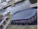 Backyard featuring above ground pool with cover and a bar and stools at 6728 Sea Ranch Dr, Hudson, FL 34667