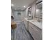 Bathroom with double vanity and grey tile floor at 6728 Sea Ranch Dr, Hudson, FL 34667