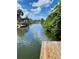 Tranquil view of a canal with lush greenery, featuring a boat dock and reflective water at 6728 Sea Ranch Dr, Hudson, FL 34667