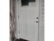 White front door with classic panel design and a glass window, offering a bright and welcoming entrance at 6728 Sea Ranch Dr, Hudson, FL 34667