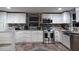 Modern kitchen with white cabinets, stainless steel appliances, and granite countertops at 6728 Sea Ranch Dr, Hudson, FL 34667