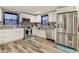 Modern kitchen with white cabinets, stainless steel appliances, and granite countertops at 6728 Sea Ranch Dr, Hudson, FL 34667