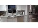 Modern kitchen with white cabinets, stainless steel appliances, and granite countertops at 6728 Sea Ranch Dr, Hudson, FL 34667