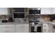 Modern kitchen with white cabinets, stainless steel appliances, and granite countertops at 6728 Sea Ranch Dr, Hudson, FL 34667