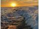 Ocean sunset with waves crashing, illuminated by vibrant golden light at 6728 Sea Ranch Dr, Hudson, FL 34667