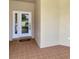 Front entrance with a white door and terracotta tile flooring at 2771 Whispering Pine Ln, North Port, FL 34287