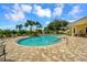 Community pool area with patio and landscaping at 2771 Whispering Pine Ln, North Port, FL 34287