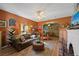 Cozy living room with leather couch, wood floors, and fireplace at 3547 6Th S St, St Petersburg, FL 33705